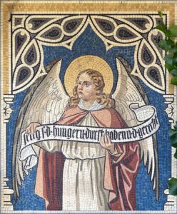 Mosaik eines Engels mit Flügeln, der ein Banner mit einer Inschrift hält, umrahmt von einem dekorativen Muster.